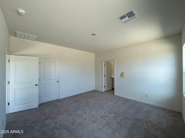 unfurnished bedroom featuring dark colored carpet