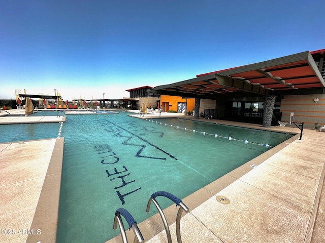 view of swimming pool with a patio