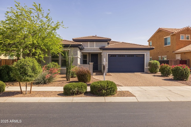 20233 E Maya Rd, Queen Creek, AZ 85142 - view of front of property featuring decorative driveway, an attached garage, stucco siding, a tiled roof, and fence