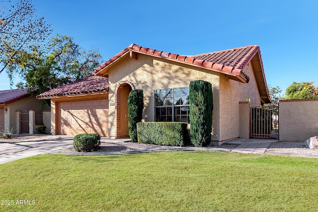 mediterranean / spanish house with a garage and a front yard