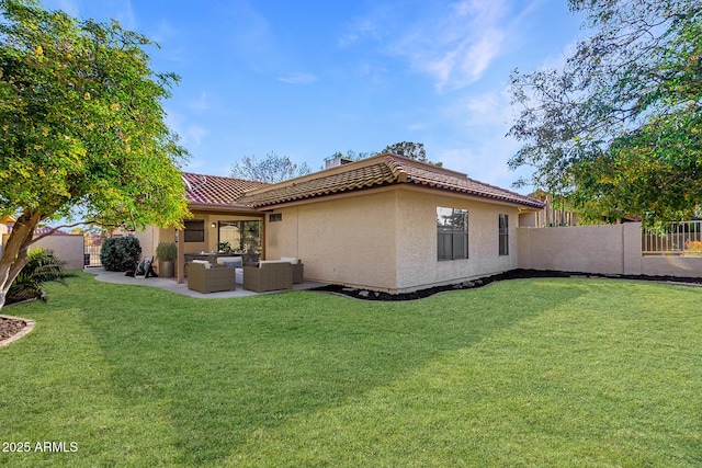 back of house with an outdoor living space, a yard, and a patio area