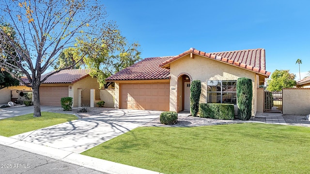 mediterranean / spanish-style home with a garage and a front lawn