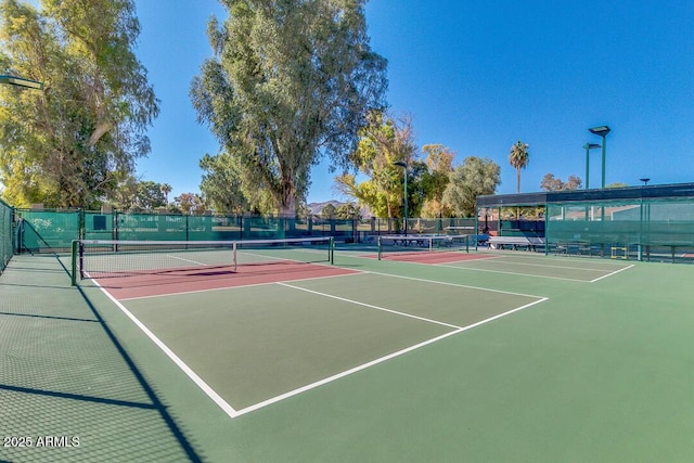 view of tennis court featuring basketball hoop