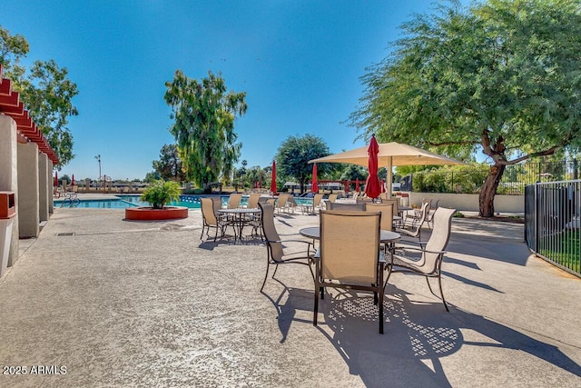 view of patio featuring a water view and a community pool