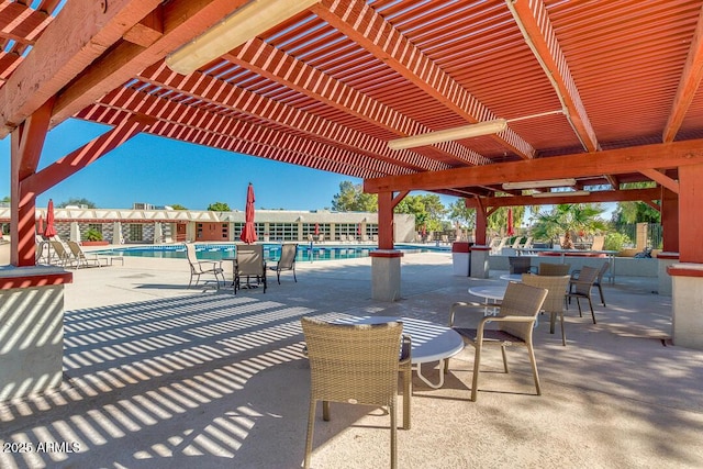 view of patio / terrace featuring a community pool and a pergola