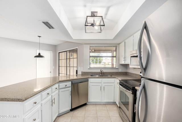 kitchen featuring white cabinetry, stainless steel appliances, and kitchen peninsula