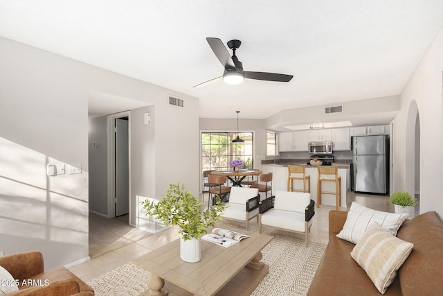 living room with ceiling fan and light tile patterned floors