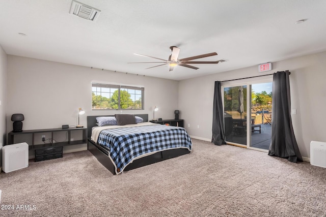 bedroom with access to exterior, ceiling fan, carpet floors, and multiple windows