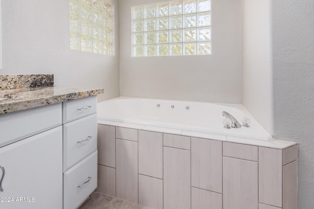 bathroom with a bath and vanity