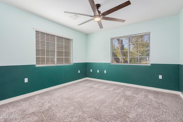 carpeted spare room with ceiling fan