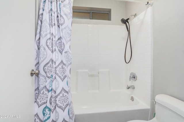 bathroom featuring shower / bath combo and toilet