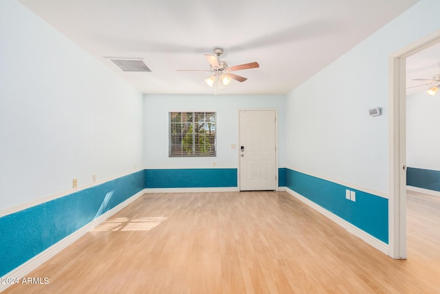 unfurnished room with hardwood / wood-style flooring and ceiling fan