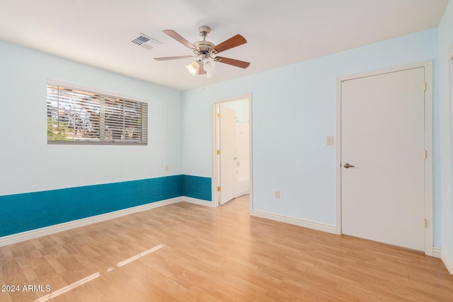 empty room featuring ceiling fan and light hardwood / wood-style flooring