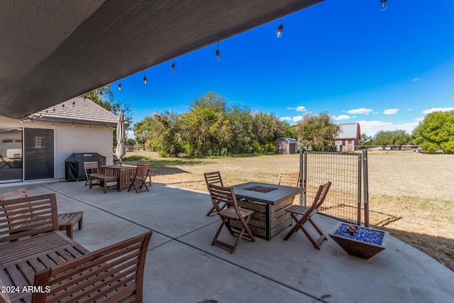 view of patio featuring grilling area and an outdoor fire pit