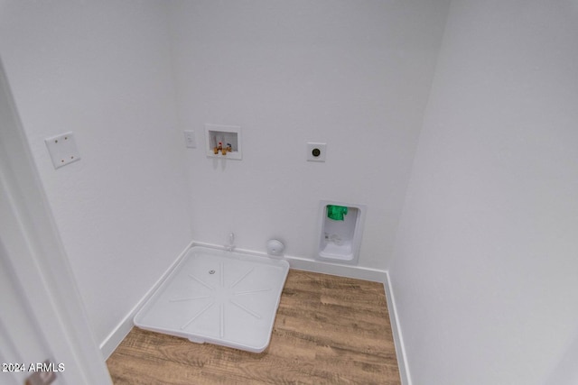 clothes washing area with washer hookup, hardwood / wood-style flooring, gas dryer hookup, and electric dryer hookup