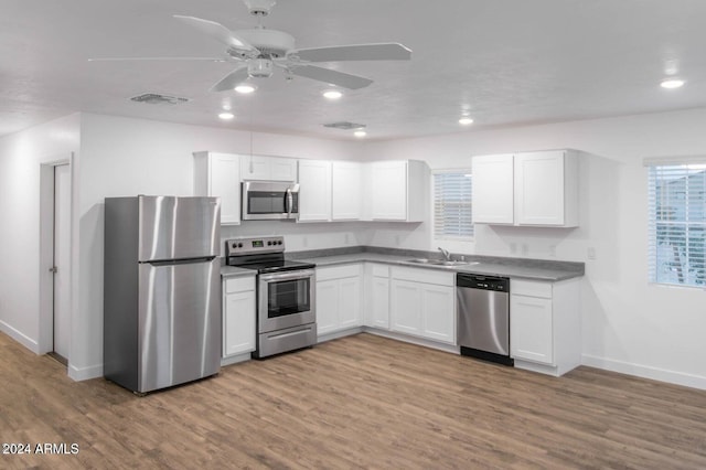 kitchen featuring sink, white cabinets, stainless steel appliances, and light hardwood / wood-style flooring