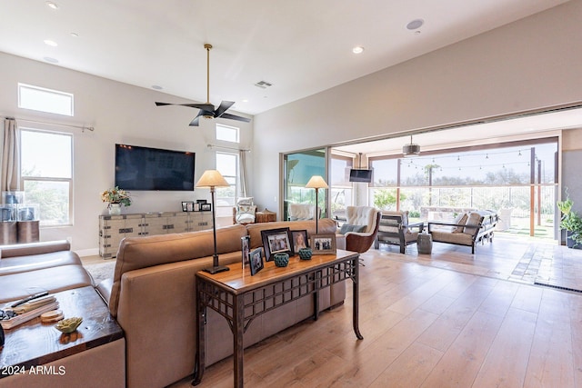 living room featuring ceiling fan and light hardwood / wood-style flooring