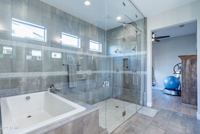 bathroom with hardwood / wood-style floors, ceiling fan, and separate shower and tub