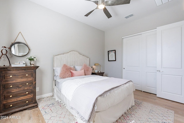 bedroom with ceiling fan, a closet, and light hardwood / wood-style flooring