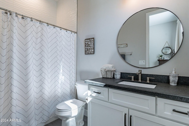 bathroom with vanity, toilet, and curtained shower