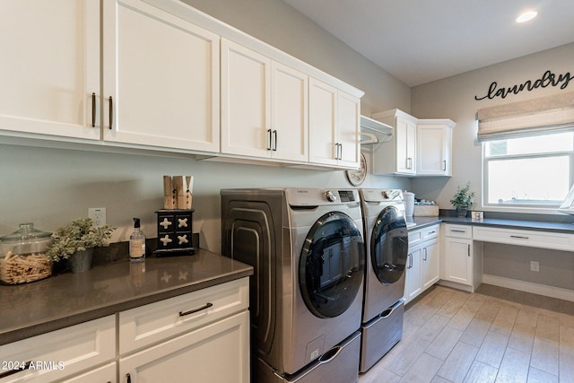 clothes washing area featuring washer and dryer, cabinets, and light hardwood / wood-style floors