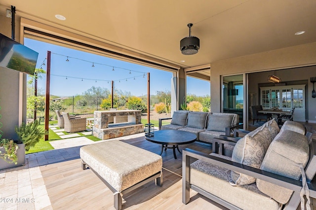 view of patio / terrace with an outdoor living space with a fireplace