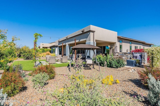 back of house featuring an outdoor hangout area, area for grilling, and a patio area