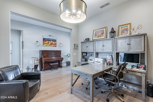 office area with light hardwood / wood-style floors