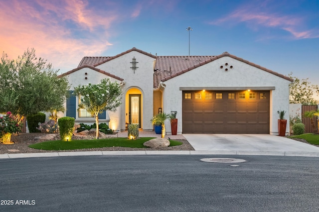 16987 W Princeton Ave, Goodyear, AZ 85395 - mediterranean / spanish home with a tile roof, concrete driveway, stucco siding, and an attached garage
