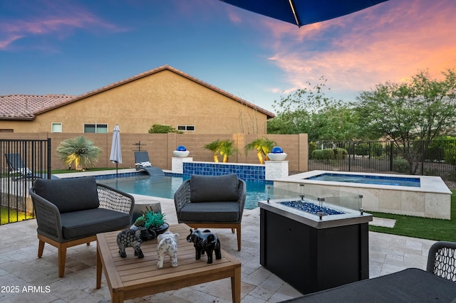 16987 W Princeton Ave, Goodyear, AZ 85395 - fenced backyard featuring a hot tub, a patio area, and an outdoor living space with a fire pit