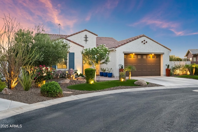 16987 W Princeton Ave, Goodyear, AZ 85395 - mediterranean / spanish-style house with an attached garage, concrete driveway, stucco siding, and a tile roof