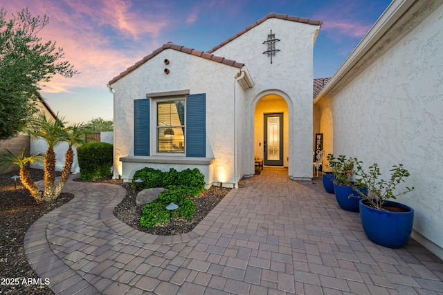16987 W Princeton Ave, Goodyear, AZ 85395 - exterior entry at dusk with stucco siding and a tile roof