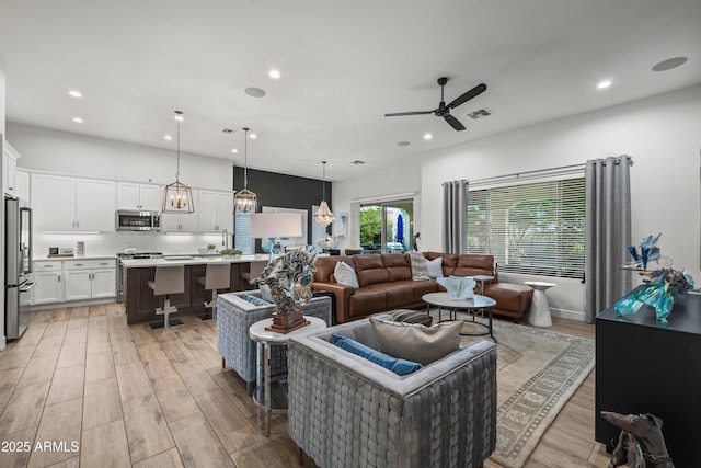 16987 W Princeton Ave, Goodyear, AZ 85395 - living room featuring recessed lighting, a ceiling fan, and light wood-type flooring
