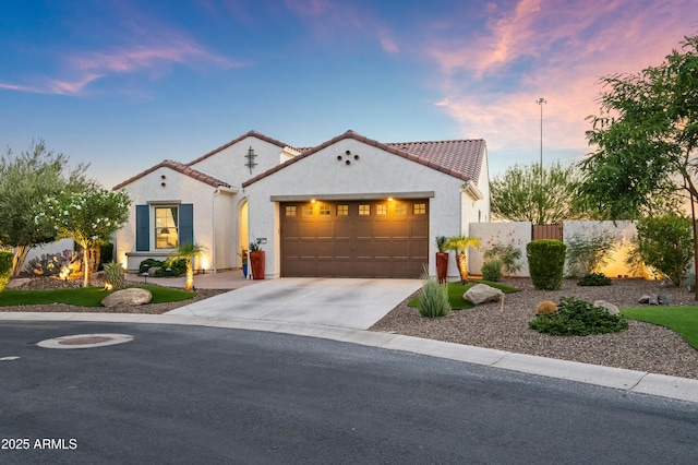 16987 W Princeton Ave, Goodyear, AZ 85395 - mediterranean / spanish house featuring an attached garage, driveway, stucco siding, and a tile roof