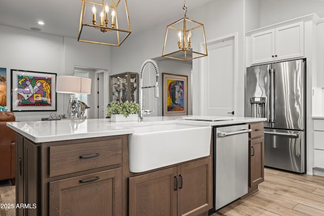 16987 W Princeton Ave, Goodyear, AZ 85395 - kitchen with stainless steel appliances, a chandelier, light wood-type flooring, light countertops, and recessed lighting