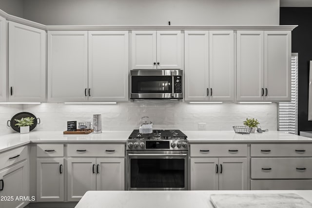 16987 W Princeton Ave, Goodyear, AZ 85395 - kitchen with appliances with stainless steel finishes, backsplash, and white cabinetry