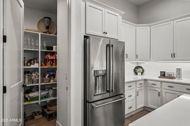 16987 W Princeton Ave, Goodyear, AZ 85395 - kitchen with high end fridge, dark wood-style floors, white cabinets, and backsplash