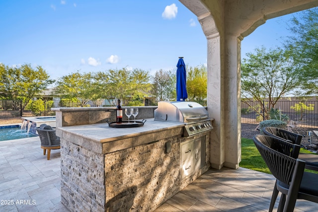 16987 W Princeton Ave, Goodyear, AZ 85395 - fenced backyard featuring an outdoor kitchen, a patio, and an outdoor bar
