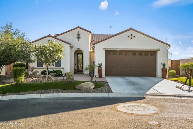 16987 W Princeton Ave, Goodyear, AZ 85395 - mediterranean / spanish house featuring driveway, an attached garage, stucco siding, and a tile roof