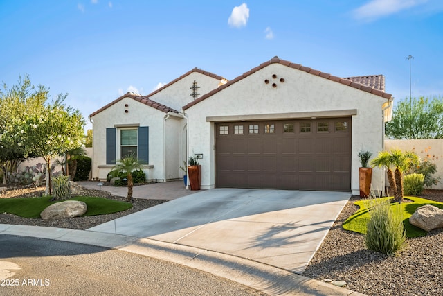 16987 W Princeton Ave, Goodyear, AZ 85395 - mediterranean / spanish-style house with a garage, stucco siding, concrete driveway, and a tiled roof