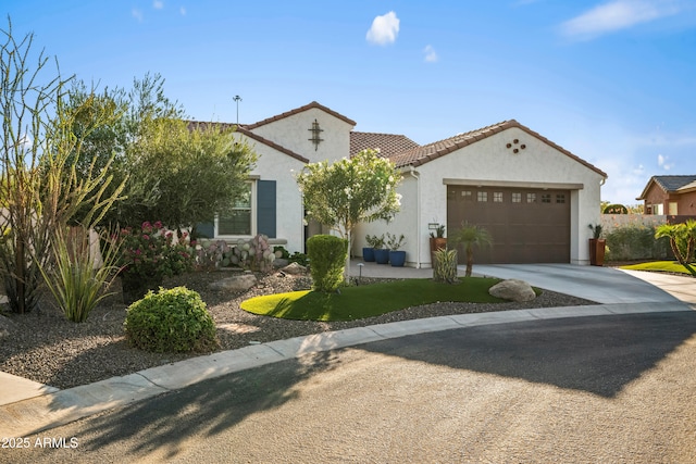 16987 W Princeton Ave, Goodyear, AZ 85395 - mediterranean / spanish home with concrete driveway, an attached garage, stucco siding, and a tile roof