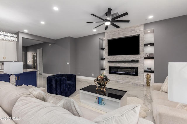 living room featuring ceiling fan and a stone fireplace