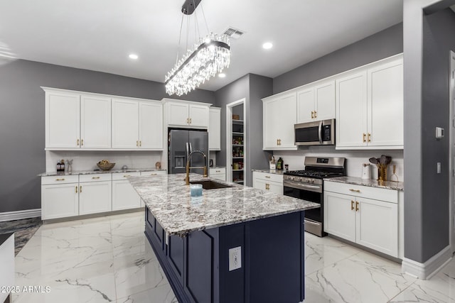 kitchen with sink, white cabinetry, hanging light fixtures, an island with sink, and stainless steel appliances