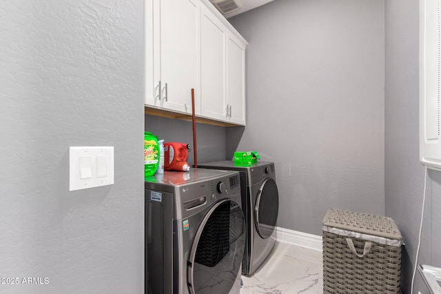 laundry room featuring cabinets and washing machine and clothes dryer