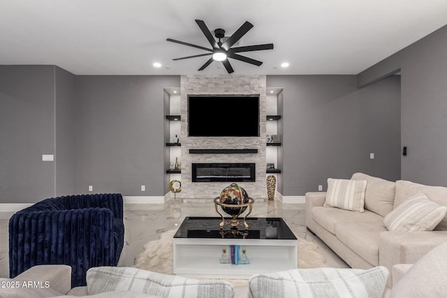 living room with ceiling fan and a fireplace