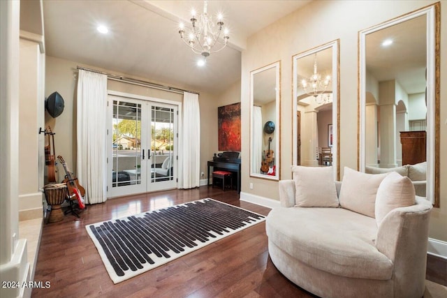 sitting room with an inviting chandelier, dark hardwood / wood-style flooring, and french doors