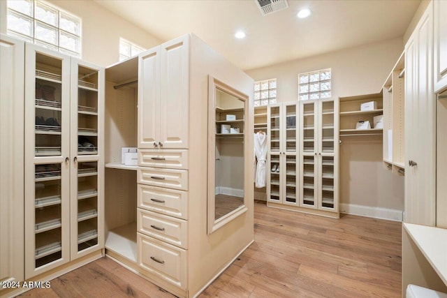 spacious closet featuring light hardwood / wood-style floors