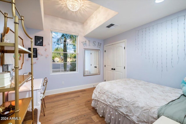 bedroom featuring light hardwood / wood-style floors and a closet