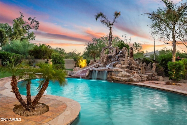 view of pool at dusk