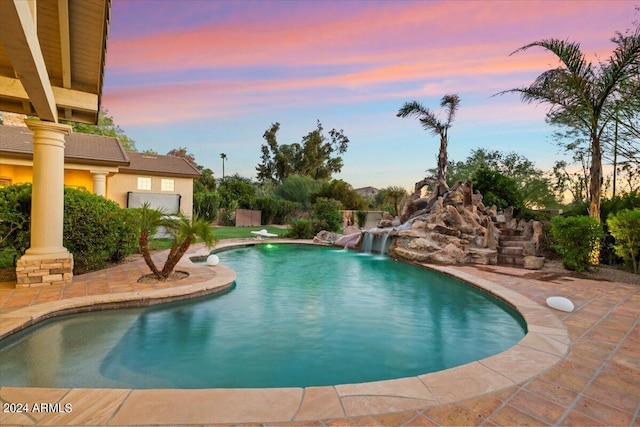 pool at dusk with pool water feature